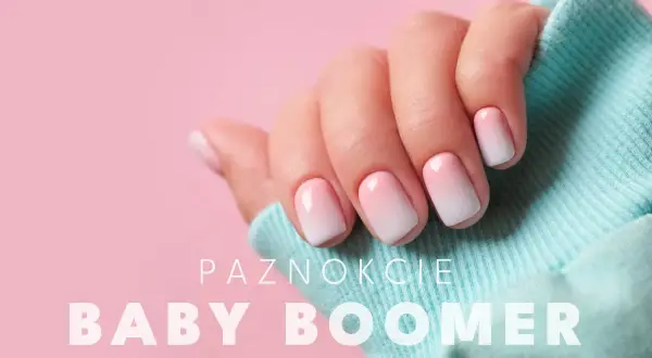 Dłoń z paznokciami w stylu ombre baby boomer. Delikatne przejście od różu do bieli, idealne na każdą okazję.