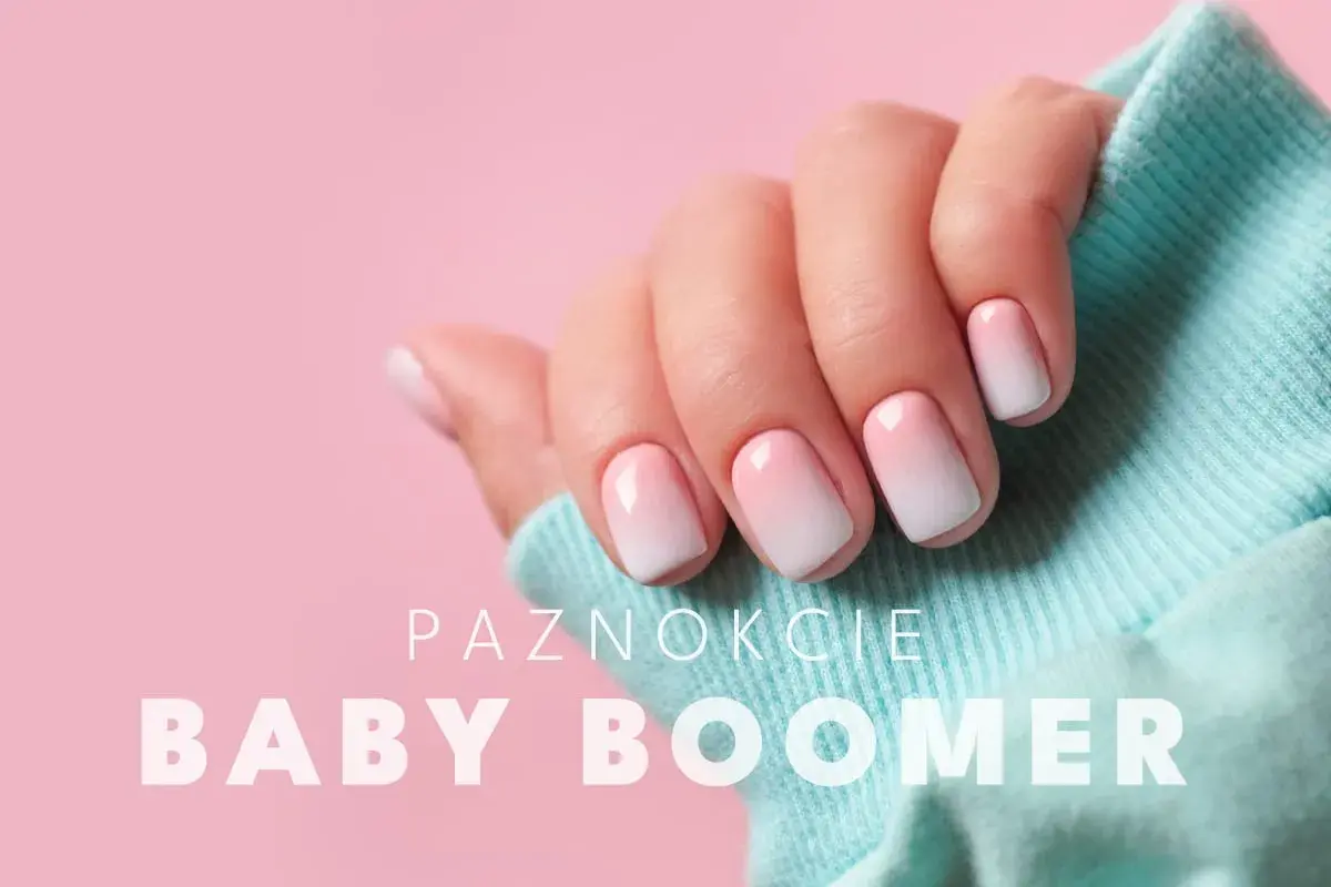 Dłoń z paznokciami w stylu ombre baby boomer. Delikatne przejście od różu do bieli, idealne na każdą okazję.